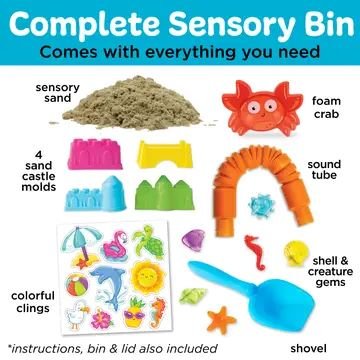 Complete sensory bin for kids with kinetic sand, foam crab, colorful sandcastle molds, ocean-themed clings, scoop, sound tube, and shell gems for autism and sensory play.